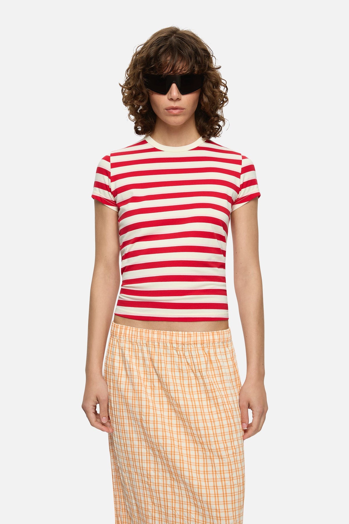 Image of a model wearing Tops. Product name - Ferris Tee Red in Red colour by brand - Blanca Studio