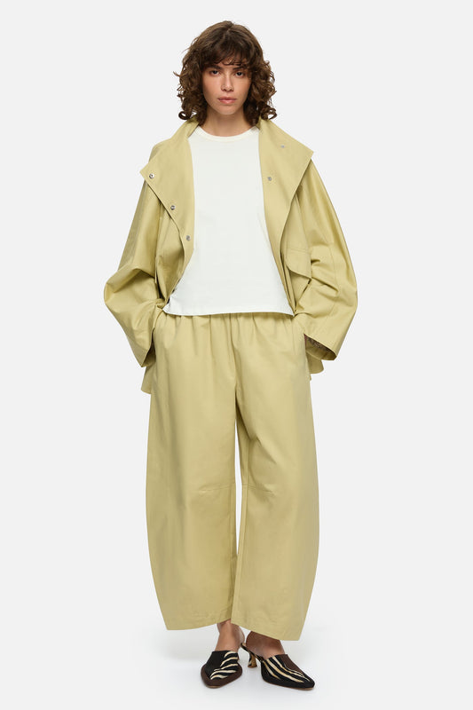 Image of a model wearing Pants. Product name - Freda Pants Cream in Cream colour by brand - Blanca Studio