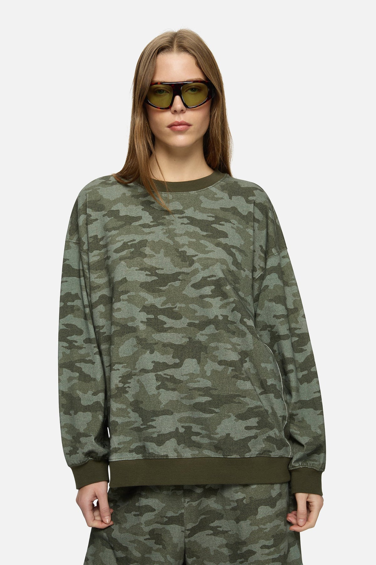 Image of a model wearing Outerwear. Product name - Indi Sweater Khaki in Khaki colour by brand - Blanca Studio