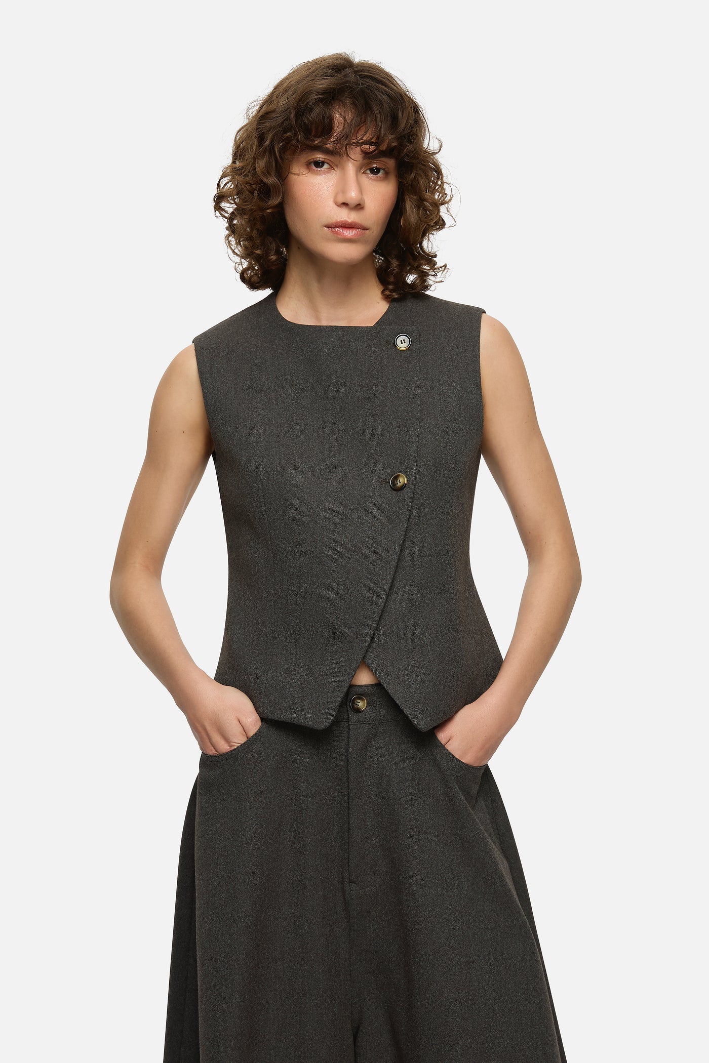Image of a model wearing Tops. Product name - Jasmine Vest Charcoal in Charcoal colour by brand - Blanca Studio
