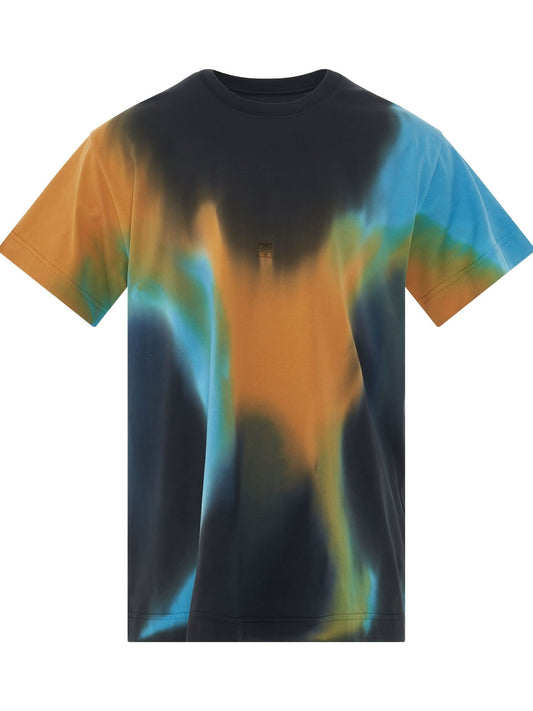 Image of a model wearing Tops. Productname: GIVENCHY 4G Embroidered Oversized Tiedye Back Cut T-Shirt in BLACK colour by brand - GIVENCHY