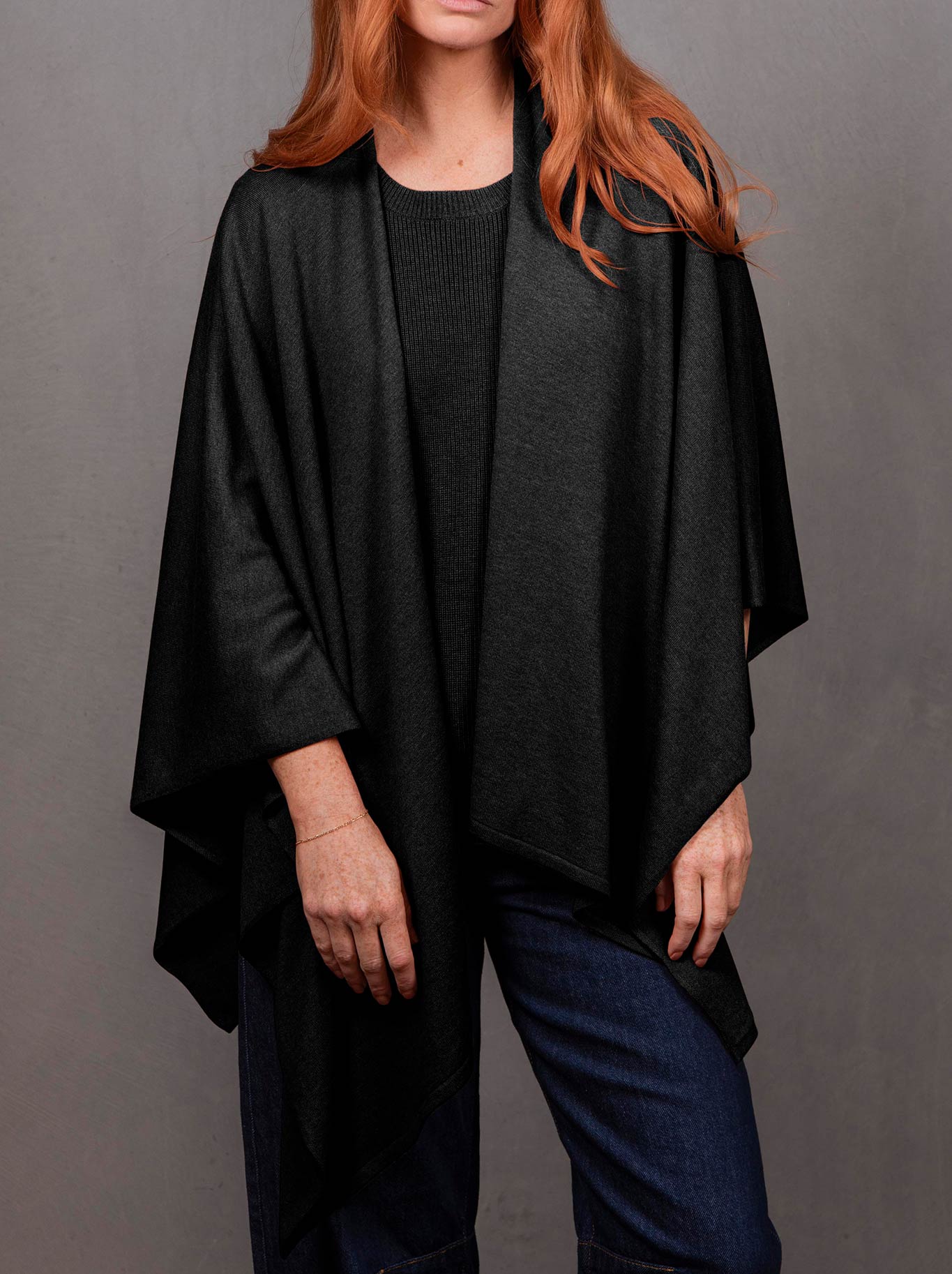 Image of a model wearing Outerwear. Product name - BRIDGE & LORD WRAP TOPPER in Black colour by brand - Bridge And Lord