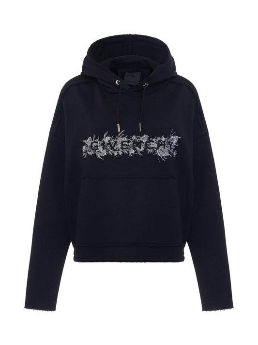 Image of a model wearing Outerwear. Productname: GIVENCHY 4G Logo Thistle Embroidered Hoodie in BLACK colour by brand - GIVENCHY