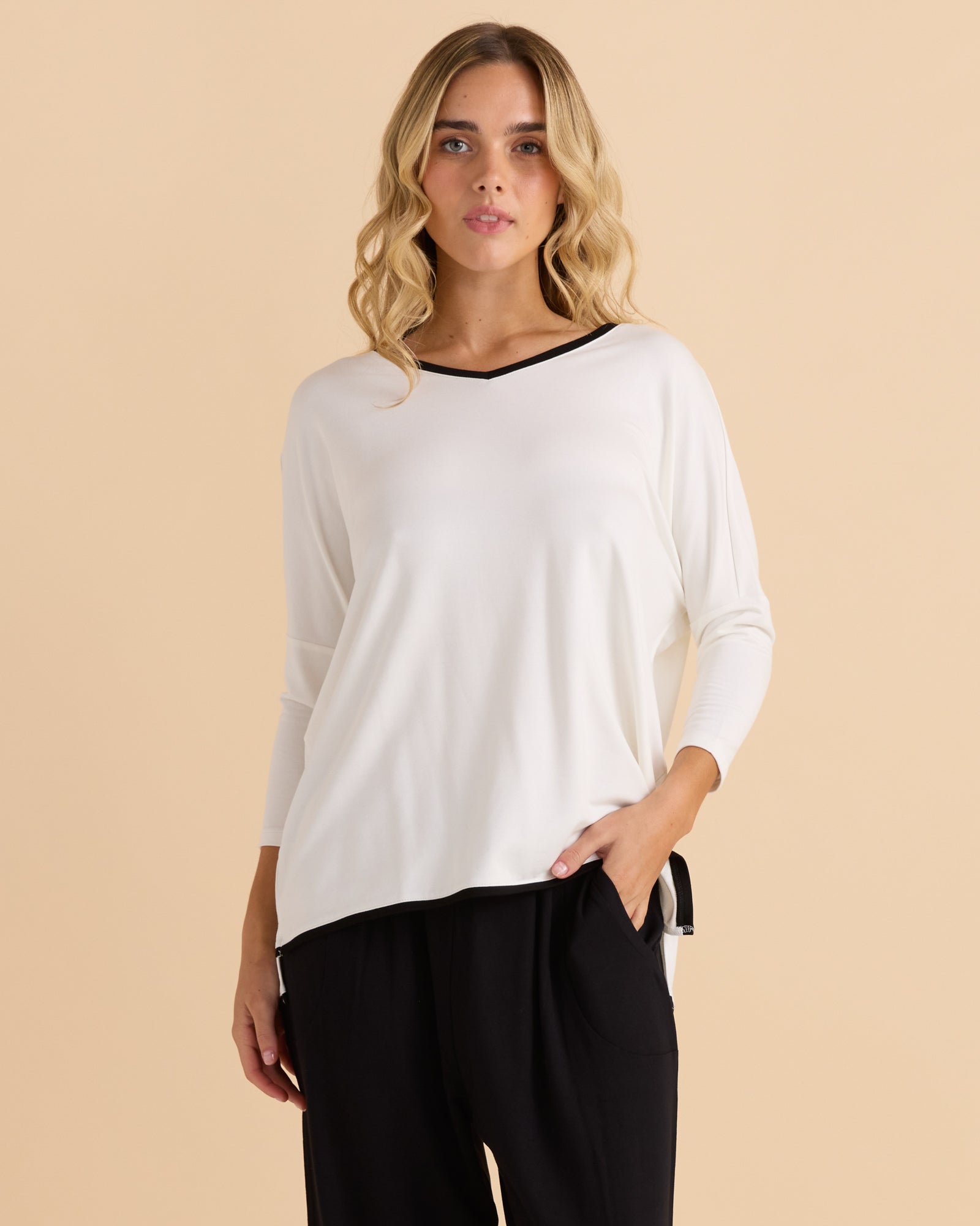 Image of a model wearing Tops. Productname: Betty Basics Adina 3/4 Sleeve Top White in White colour by brand - Betty Basics