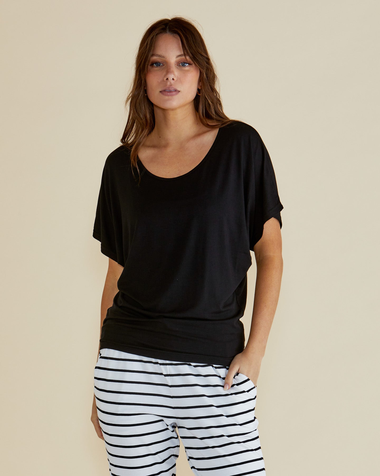 Image of a model wearing Tops. Productname: Betty Basics Maui Tee Black in Black colour by brand - Betty Basics