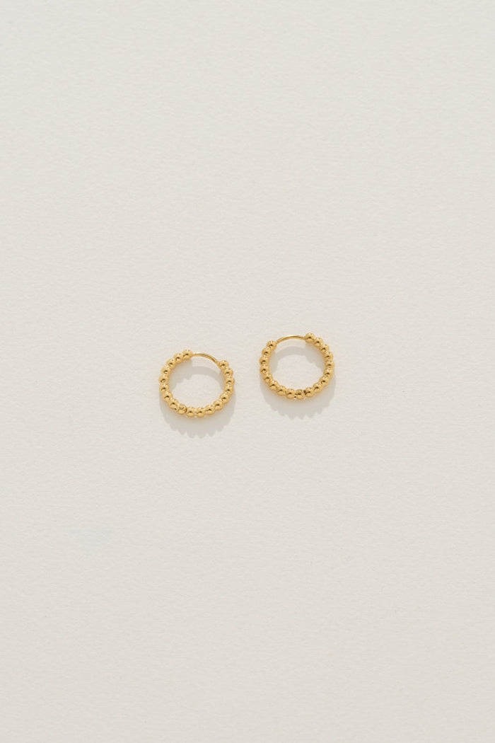 Image of Earrings. Product name - Isolde Huggies in Gold in Gold colour by brand - Reliquia Jewellery