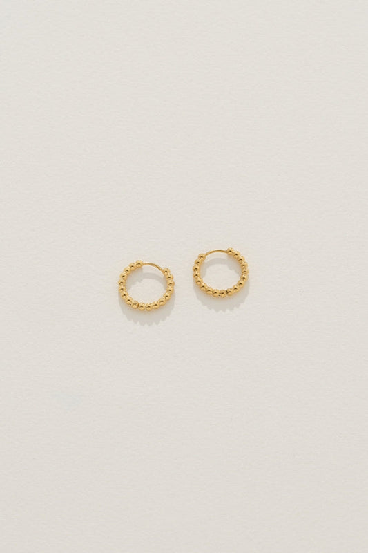 Image of Earrings. Product name - Isolde Huggies in Gold in Gold colour by brand - Reliquia Jewellery