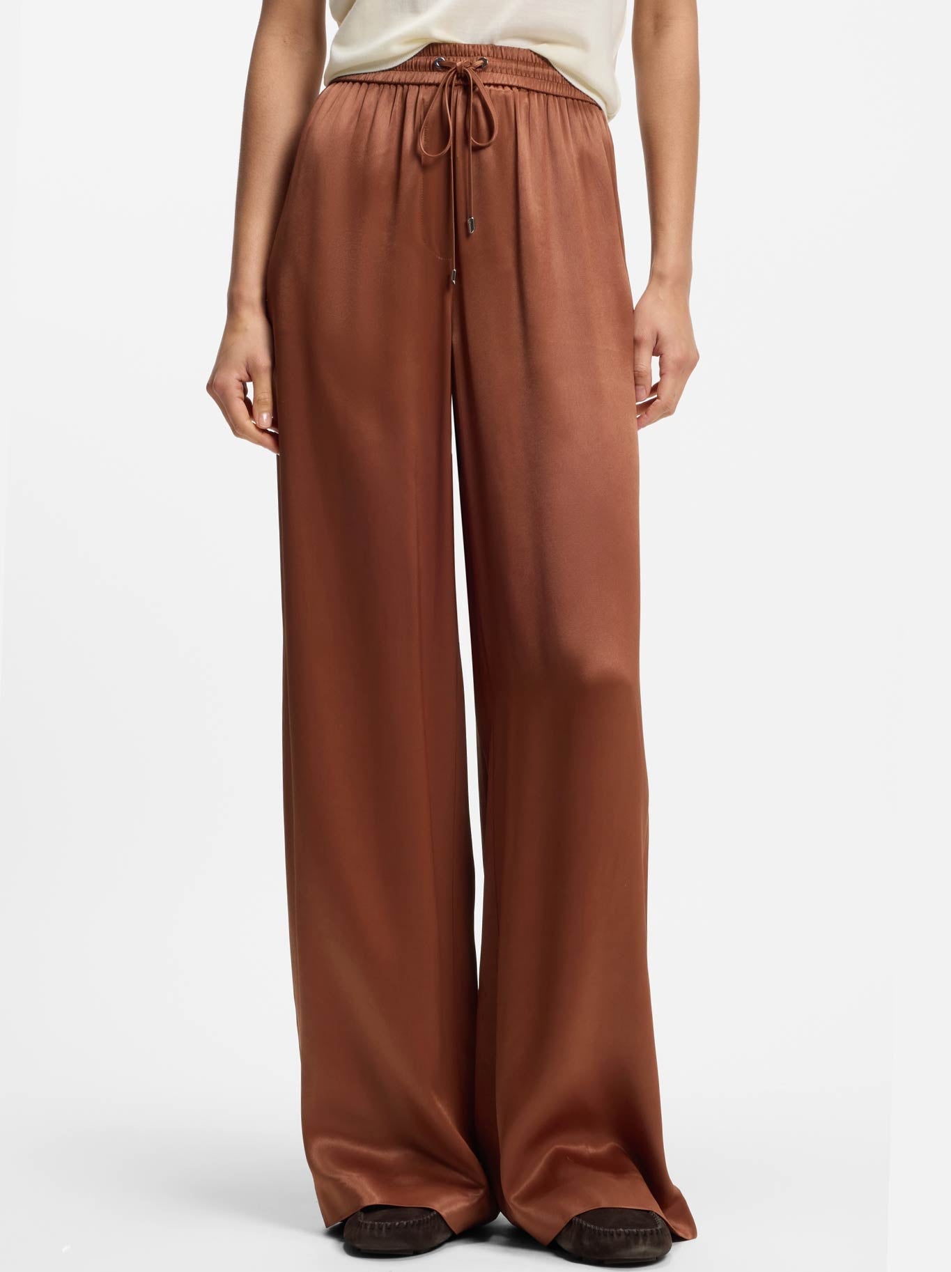 Image of a model wearing Pants. Product name - BOSS TAVATI PANT in Rust Copper colour by brand - Hugo Boss