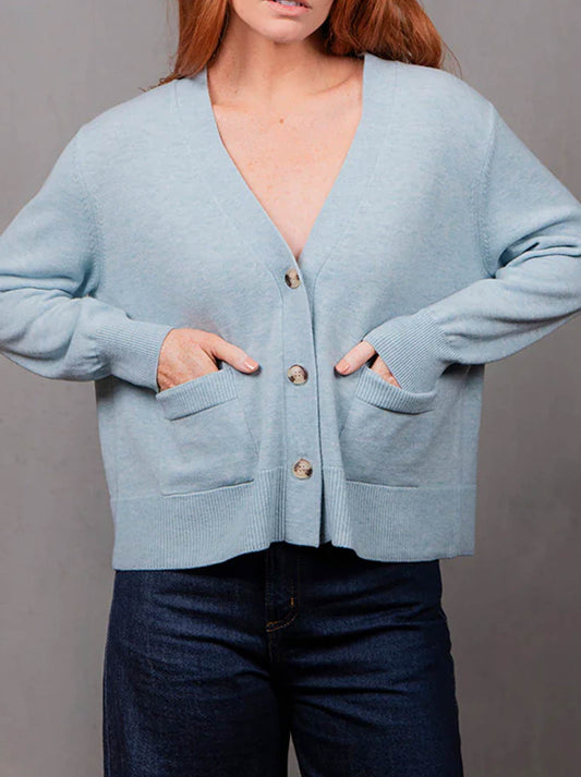Image of a model wearing Outerwear. Product name - BRIDGE & LORD VEE RELAXED CROP CARDI in Olive colour by brand - Bridge And Lord