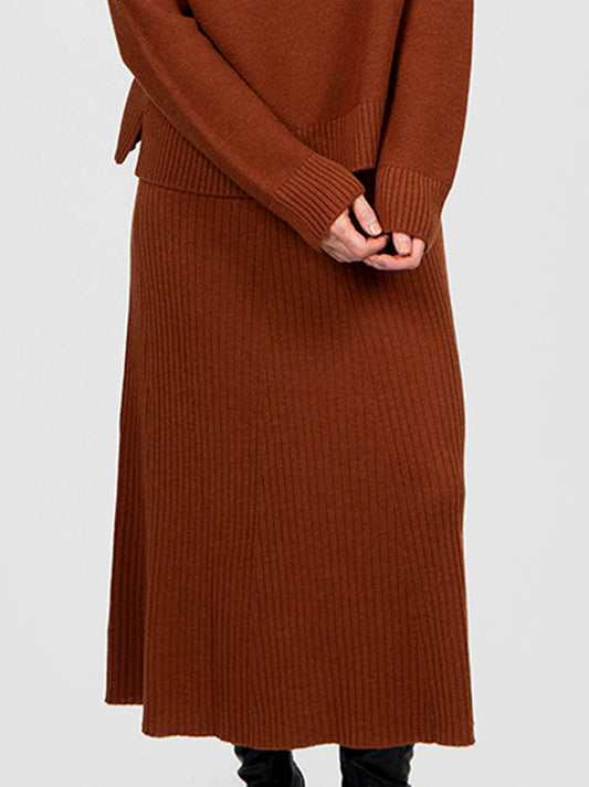 Image of a model wearing Skirts. Product name - Bridge & Lord Sophie Flared Skirt in Cognac colour by brand - Bridge And Lord