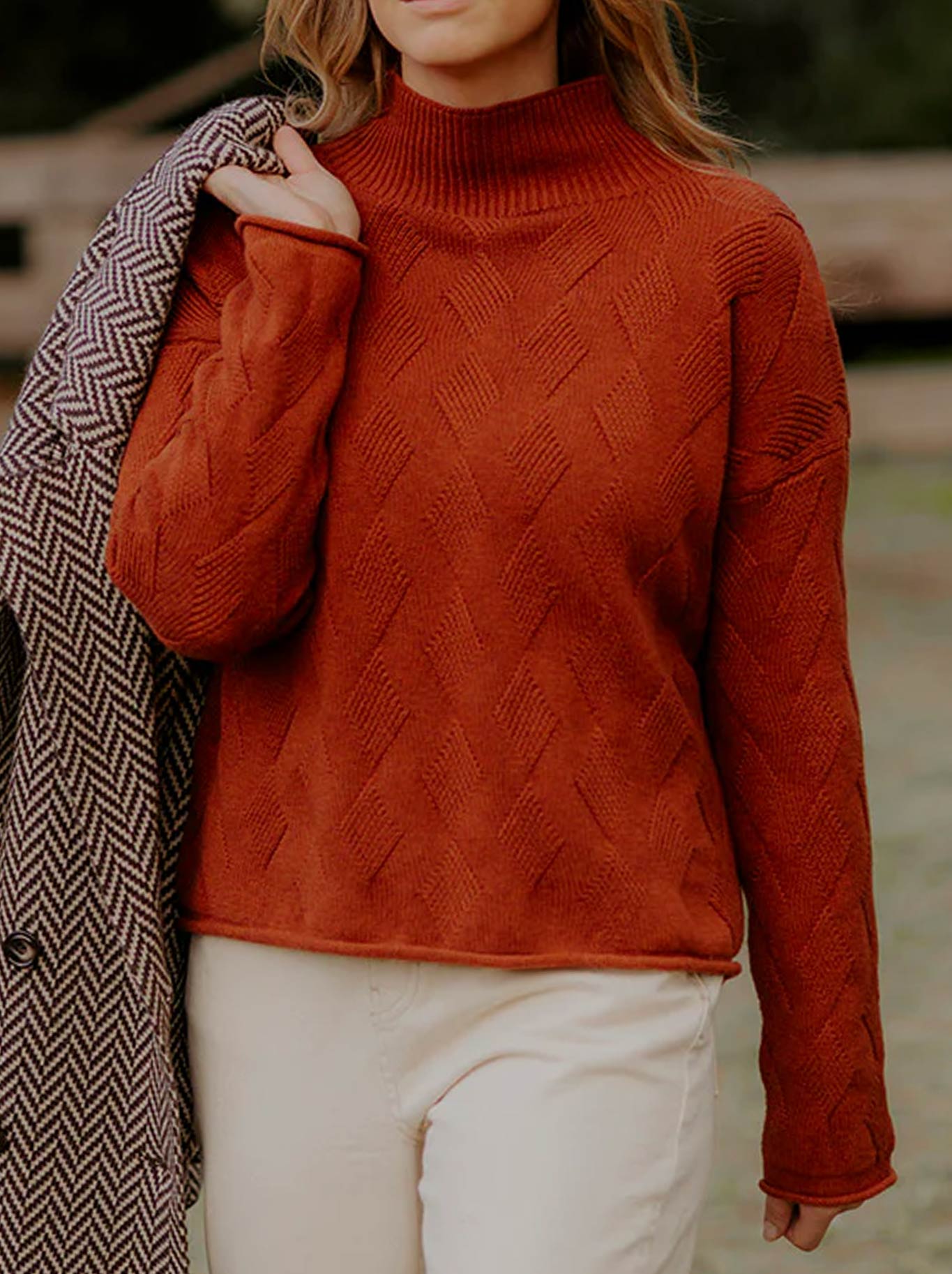 Image of a model wearing Outerwear. Product name - Fields Chevron Cable Pullover in Auburn colour by brand - Fields Knitwear