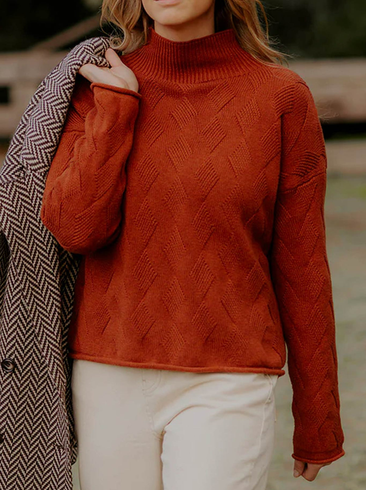 Image of a model wearing Outerwear. Product name - FIELDS CHEVRON CABLE PULLOVER in Auburn colour by brand - Fields Knitwear