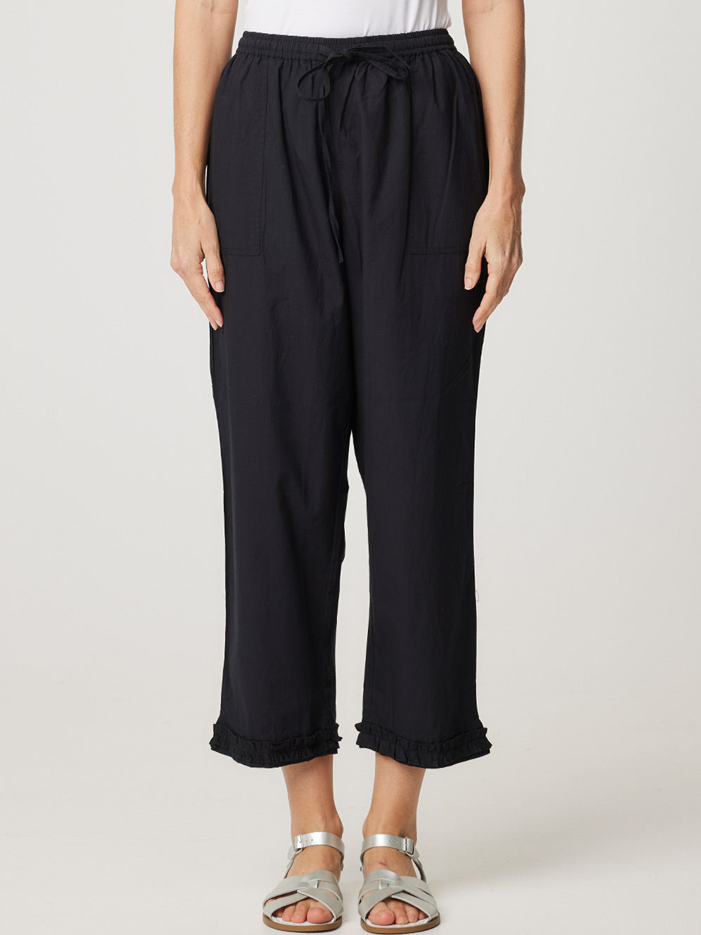 Image of a model wearing Pants. Productname: CAKE RUFFLE CARPI PANT in White colour by brand - Cake