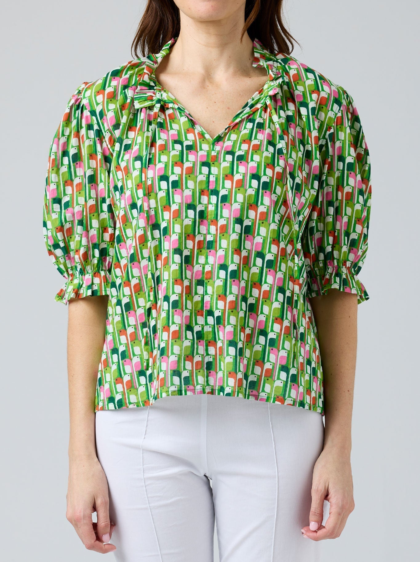 Image of a model wearing Tops. Product name - CAKE TIE NECK BLOUSE in Birdie colour by brand - Cake