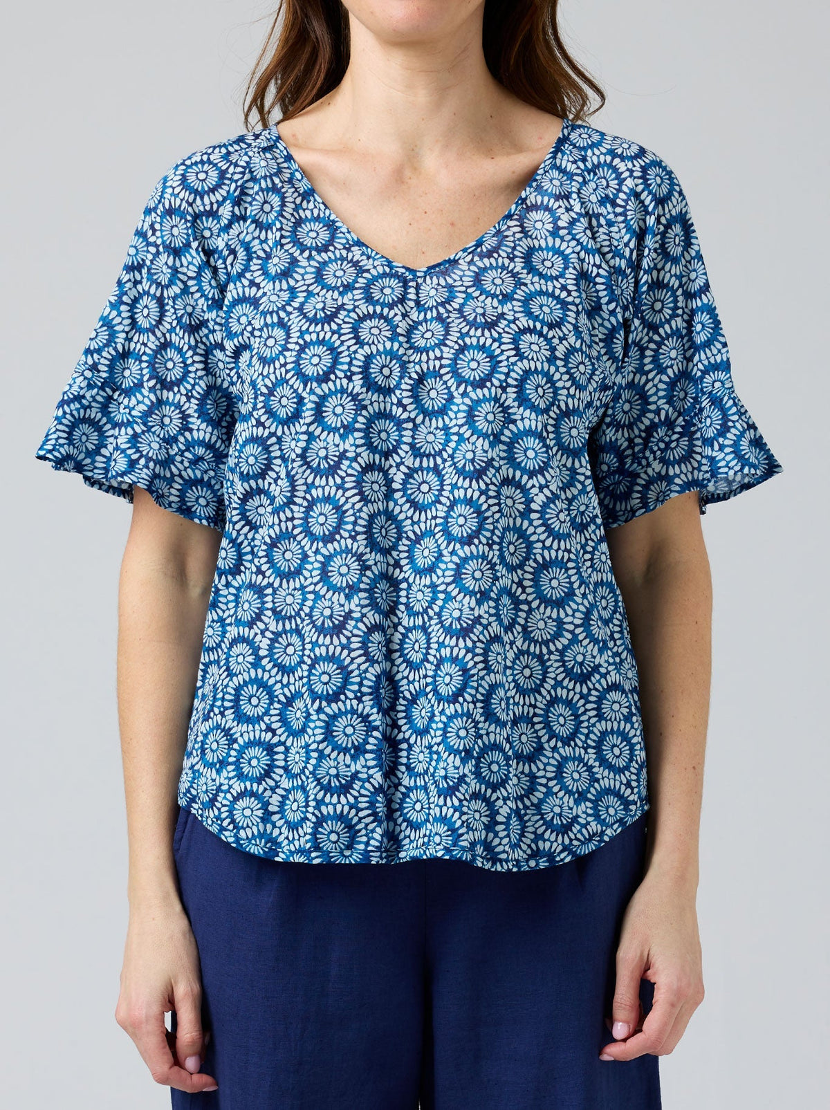 Image of a model wearing Tops. Product name - CAKE KIM TOP in Blue White Circle colour by brand - Cake