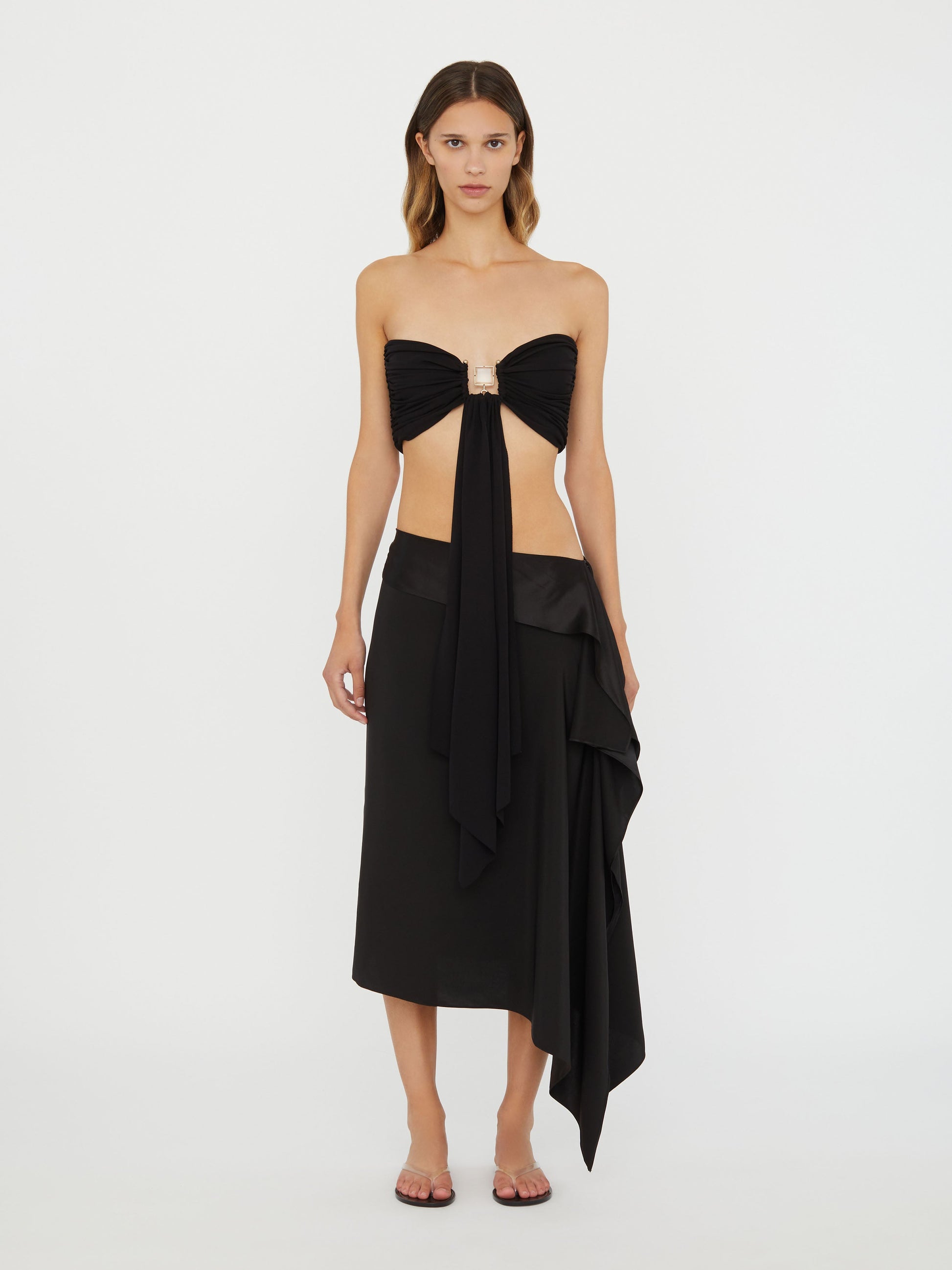 Image of a model wearing Tops. Product name - Bezel Quartz Drape Top in Black colour by brand - Christopher Esber