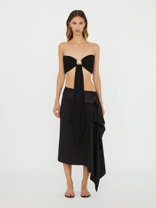 Image of a model wearing Tops. Product name - Bezel Quartz Drape Top in Black colour by brand - Christopher Esber