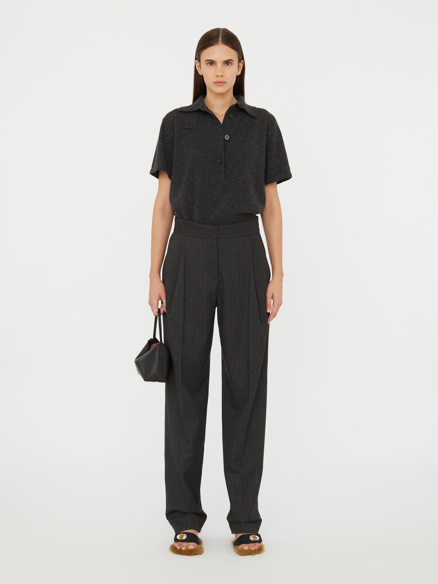 Image of a model wearing Pants. Product name - Cuffed Tailored Trouser in Stripe colour by brand - Christopher Esber
