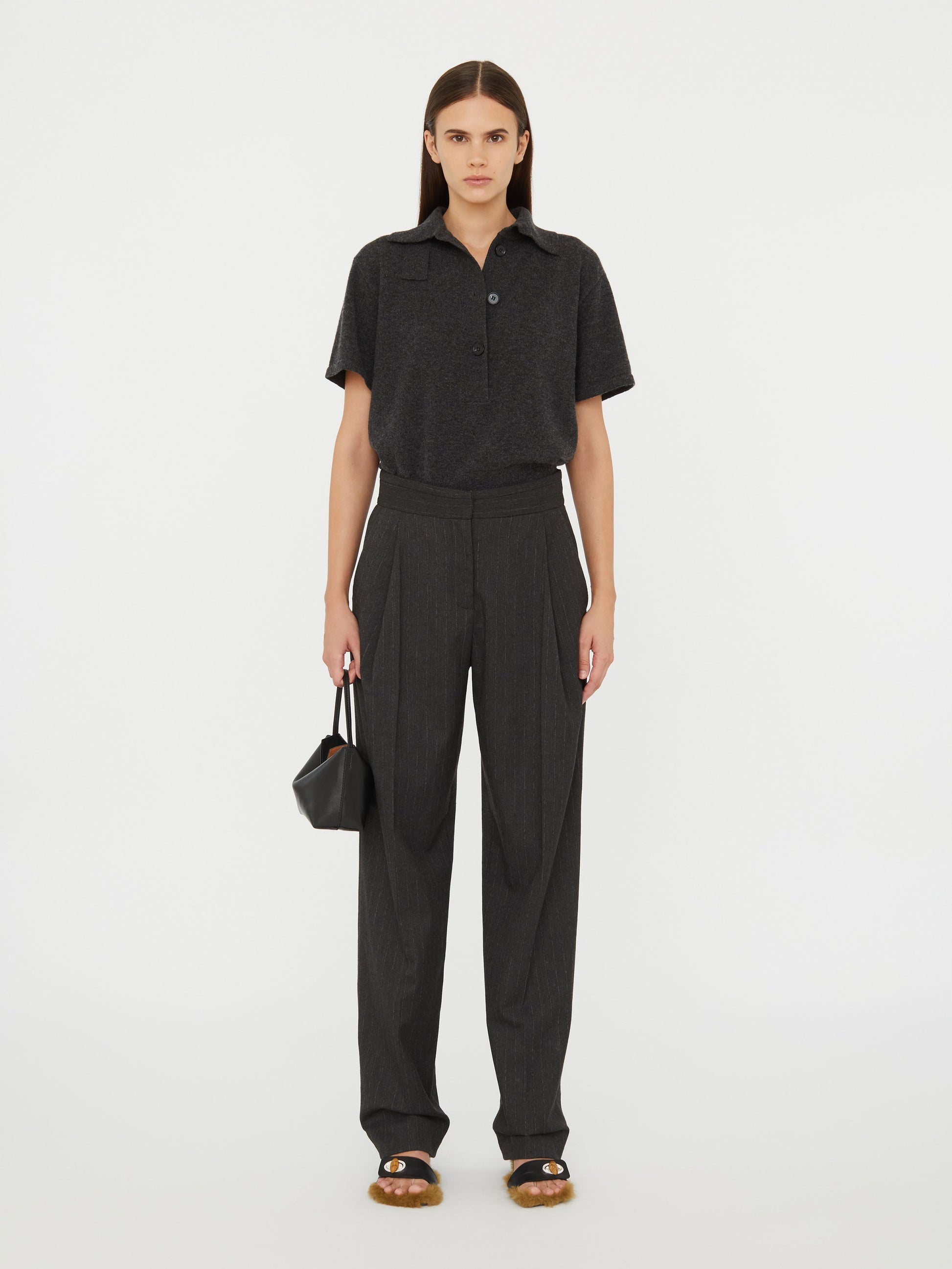 Image of a model wearing Pants. Product name - Cuffed Tailored Trouser in Stripe colour by brand - Christopher Esber