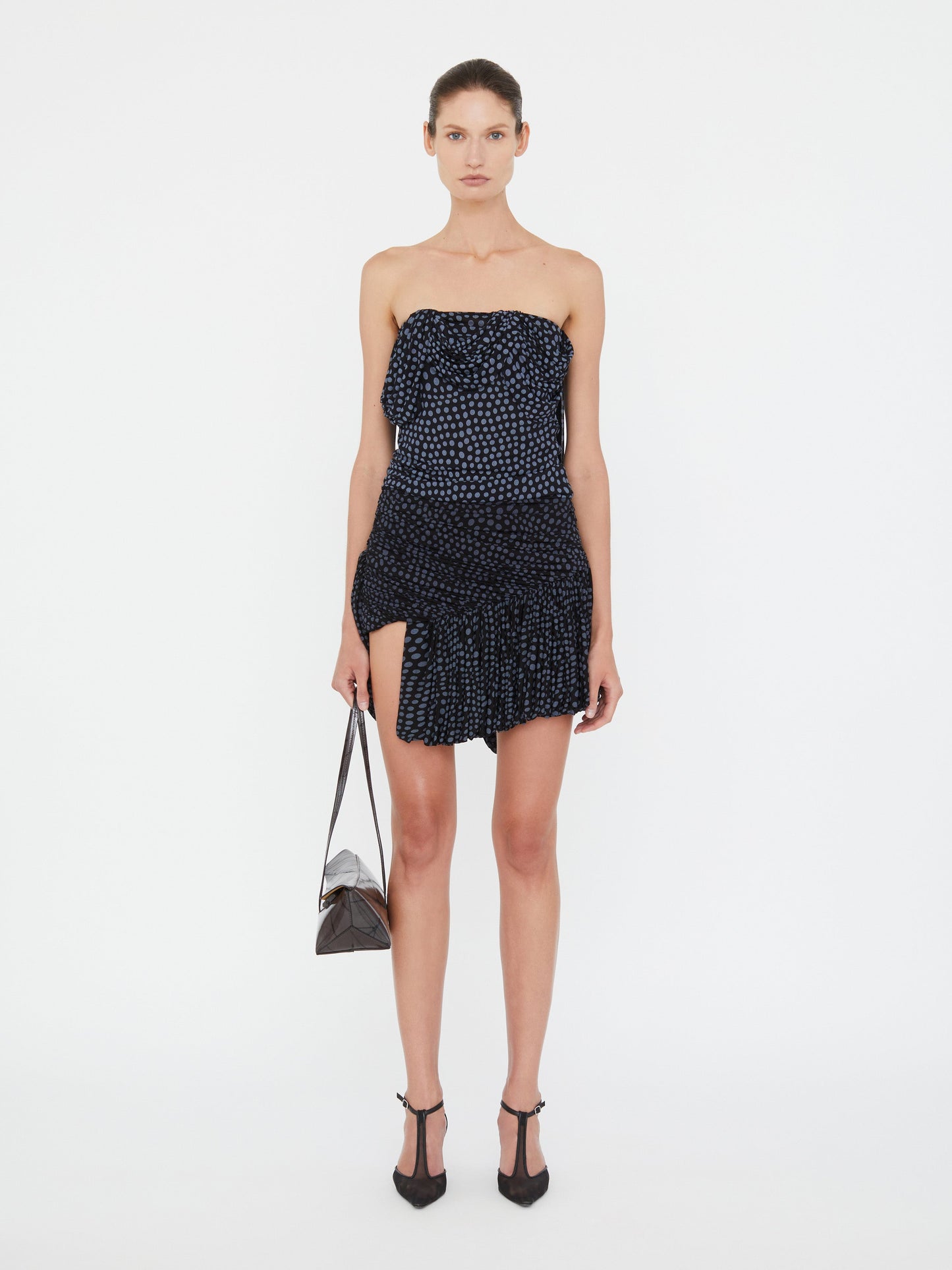Image of a model wearing Skirts. Product name - Gyre Draped Mini Skirt in Skirt colour by brand - Christopher Esber
