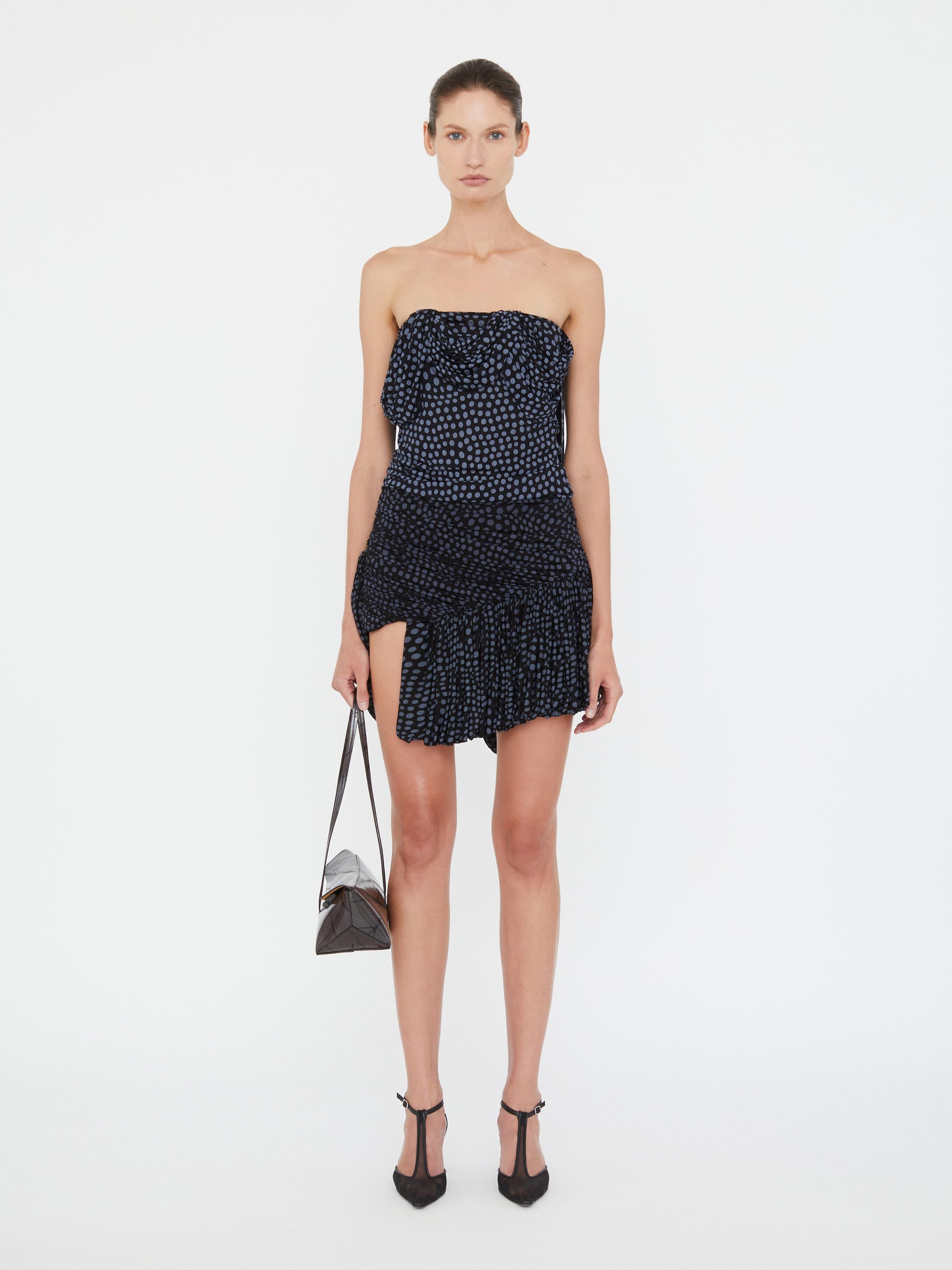 Image of a model wearing Skirts. Product name - Gyre Draped Mini Skirt in Skirt colour by brand - Christopher Esber