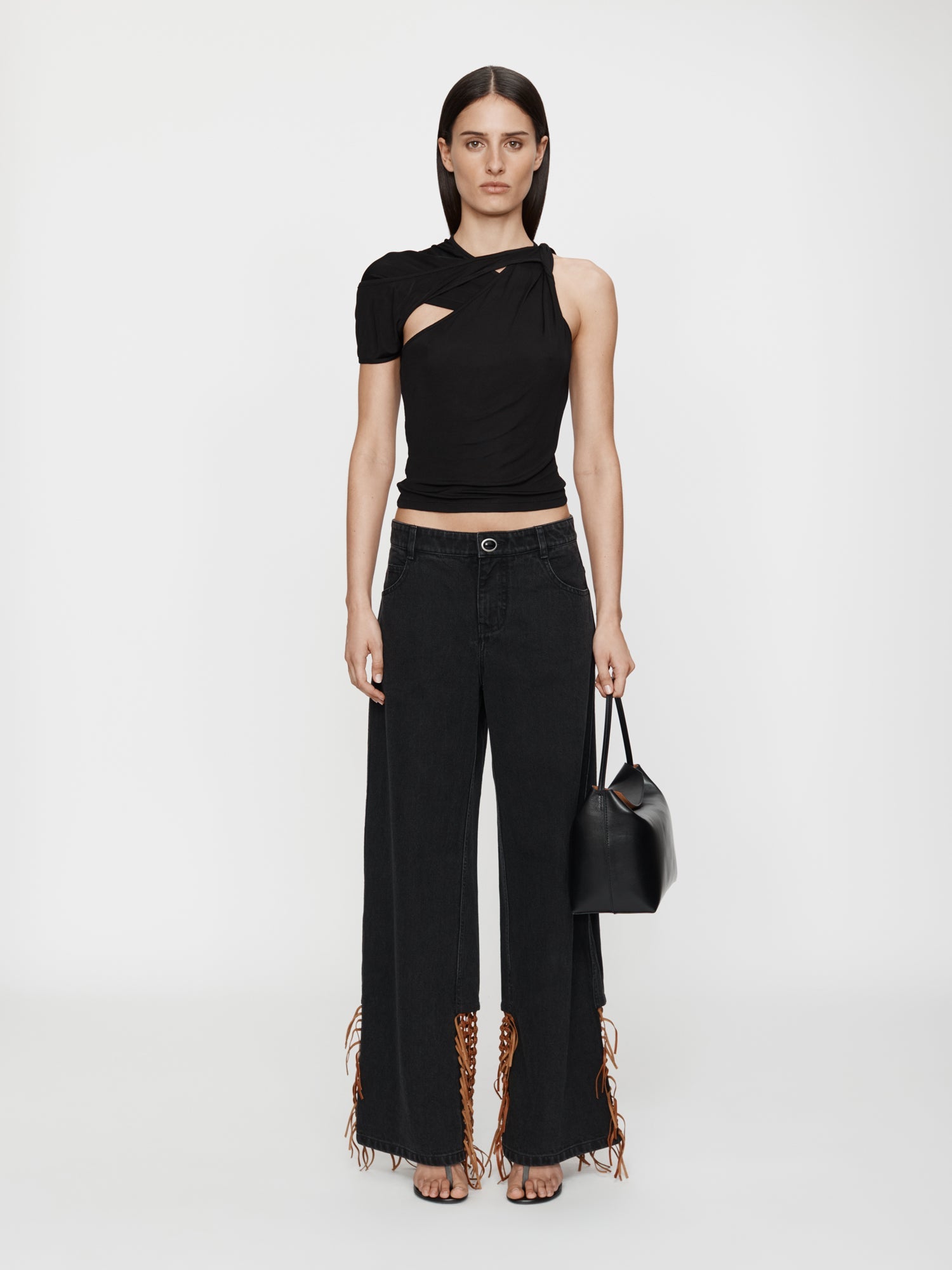 Image of a model wearing Pants. Productname: Christopher Esber Basket Leather Jean in Almond colour by brand - Christopher Esber