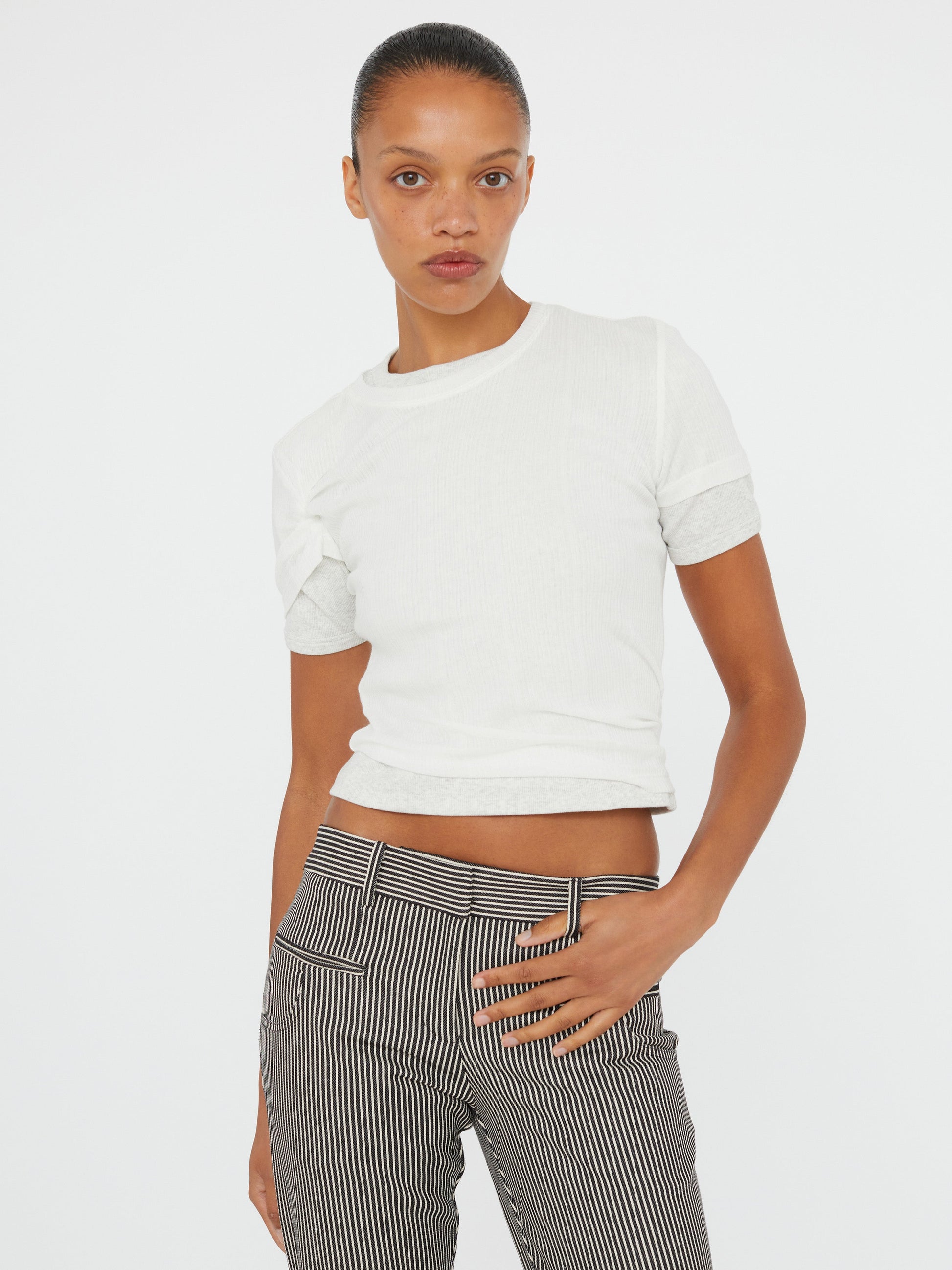 Image of a model wearing Tops. Product name - Ribbed Overlay Loophole Tee in Grey colour by brand - Christopher Esber