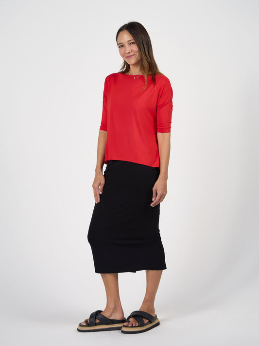 Image of a model wearing Tops. Product name - Camila 3/4 Sleeve Bamboo Top Fiery Red in Fiery Red colour by brand - Lou Lou