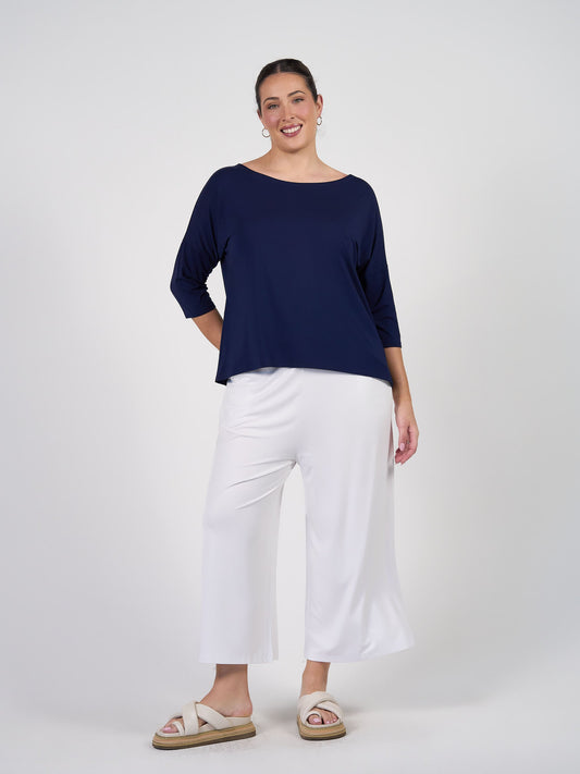 Image of a model wearing Tops. Product name - Camila 3/4 Sleeve Bamboo Top Navy in Navy colour by brand - Lou Lou