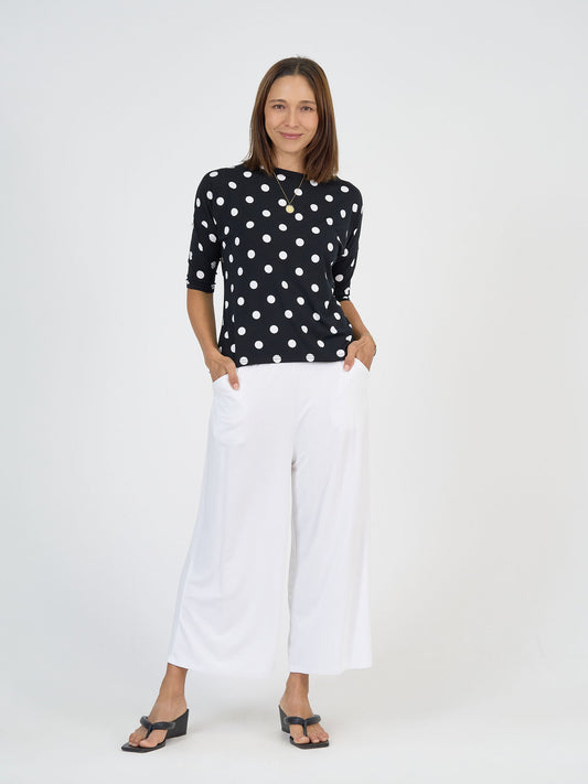 Image of a model wearing Tops. Product name - Camila 3/4 Sleeve Bamboo Top Polka Dot in Polka Dot colour by brand - Lou Lou