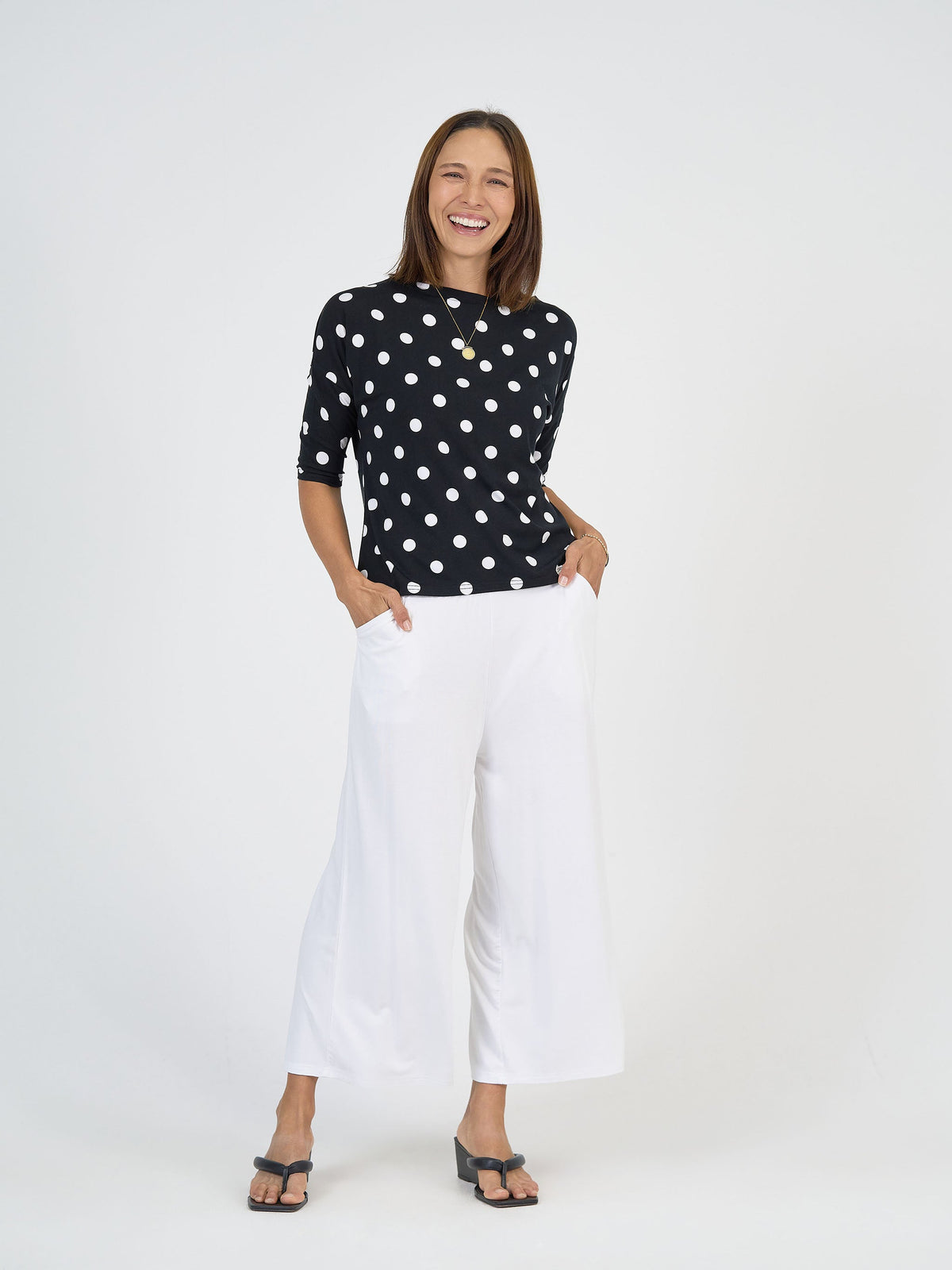 Image of a model wearing Pants. Product name - Ciara 7/8 Length Bamboo Culottes in White colour by brand - Lou Lou
