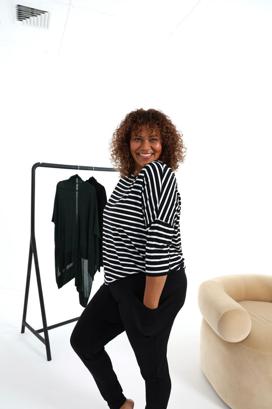 Image of a model wearing Tops. Product name - Camila 3/4 Sleeve Bamboo Top in Black & White Stripe colour by brand - Lou Lou