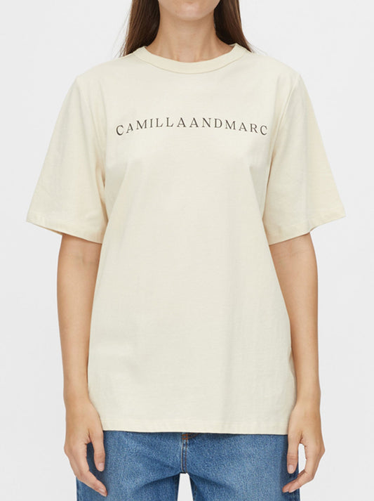Image of a model wearing Tops. Productname: CAMILLA AND MARC CAPELLA LOGO TEE in Bone colour by brand - Camilla And Marc