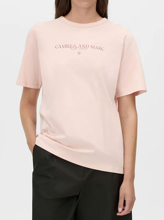 Image of a model wearing Tops. Productname: CAMILLA AND MARC GHILBERTI LOGO TEE in Sherbet colour by brand - Camilla And Marc