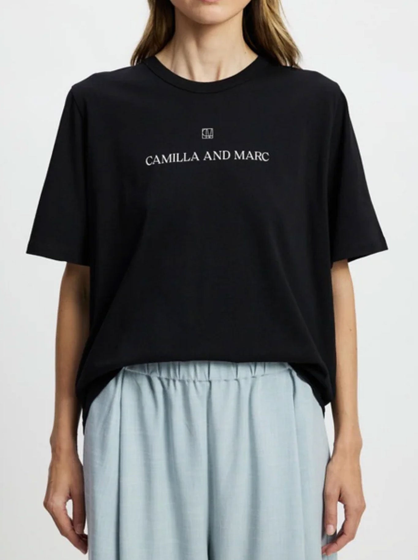 Image of a model wearing Tops. Productname: CAMILLA AND MARC GRAYSON TEE in Black colour by brand - Camilla And Marc