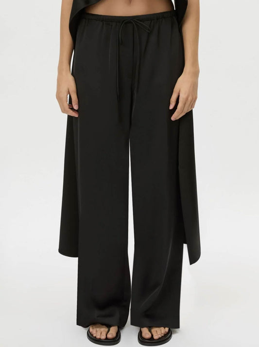 Image of a model wearing Pants. Product name - CAMILLA AND MARC GROUND SATIN PANT in Black colour by brand - Camilla And Marc
