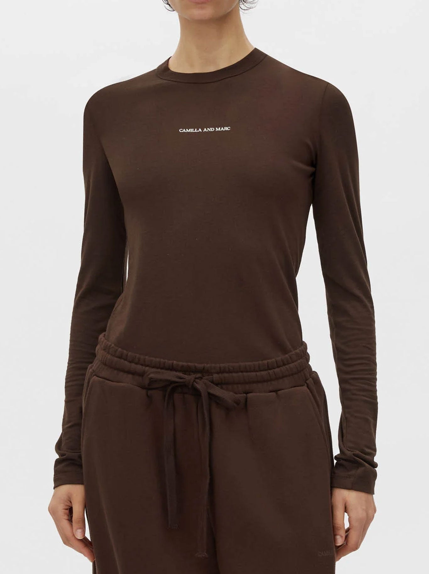 Image of a model wearing Tops. Productname: CAMILLA AND MARC PARK LONG SLEEVE LOGO TOP in Chalk colour by brand - Camilla And Marc