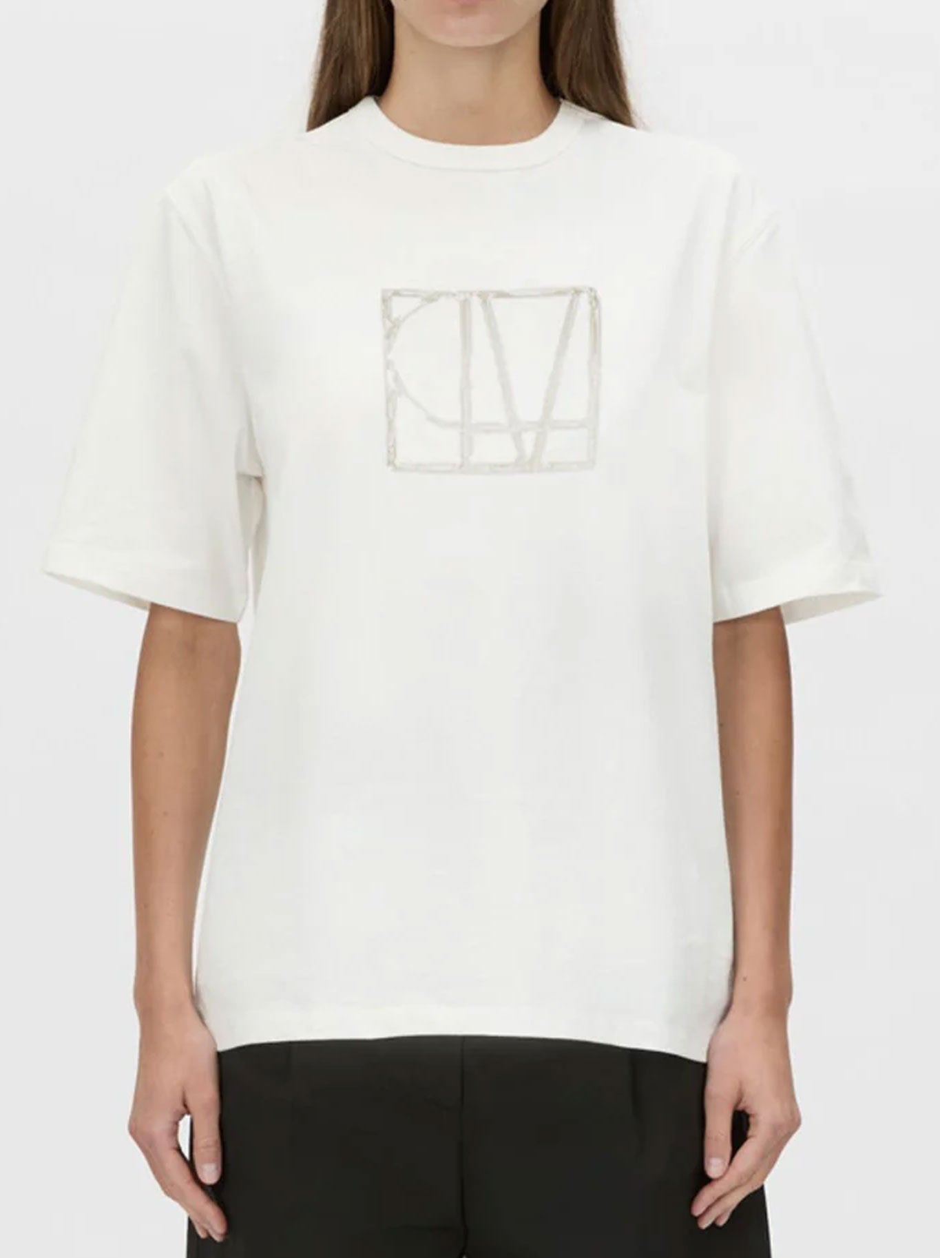 Image of a model wearing Tops. Productname: CAMILLA AND MARC PATINA FRONT MONOGRAM TEE in Soft White colour by brand - Camilla And Marc