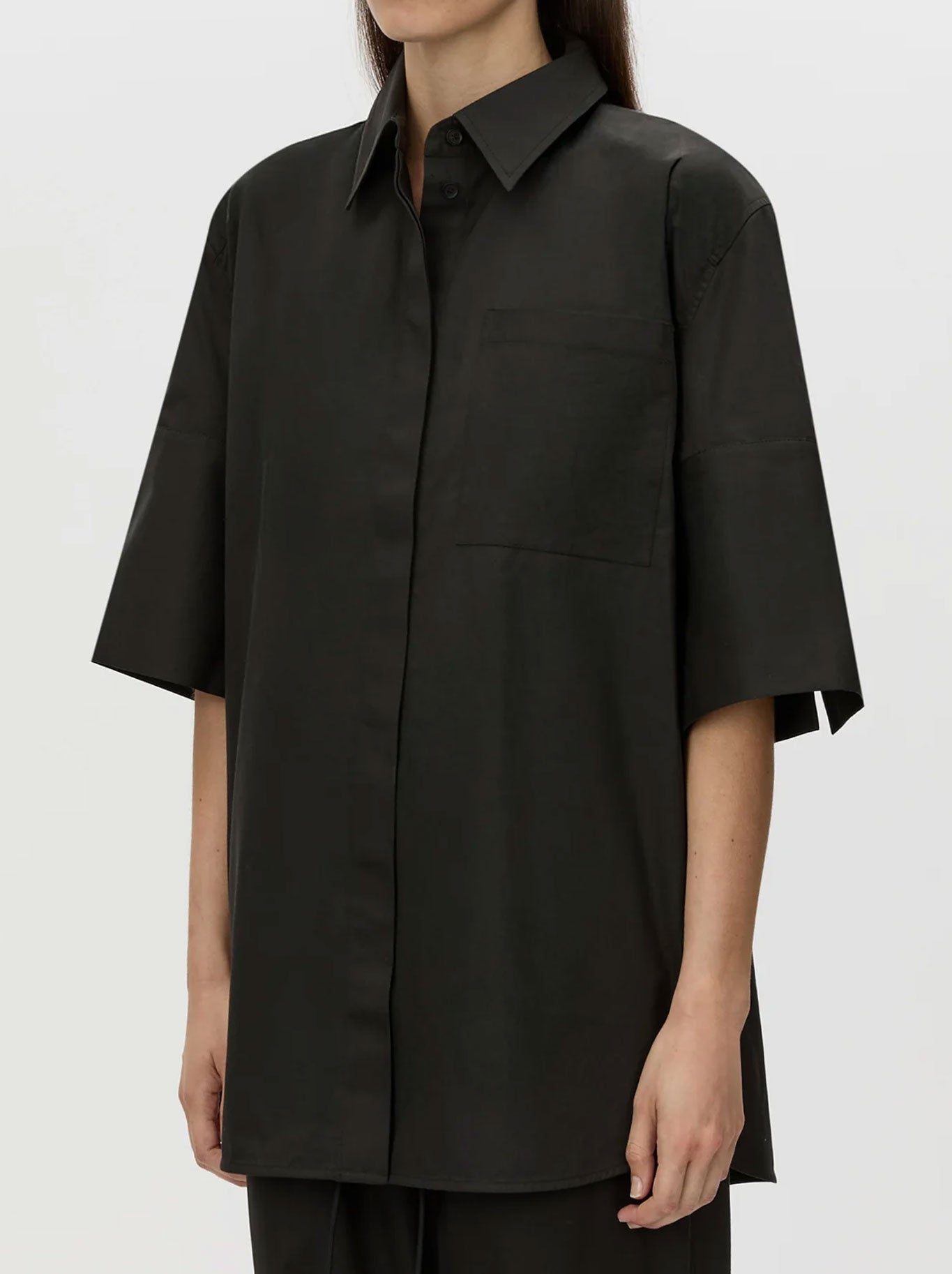 Image of a model wearing Tops. Productname: CAMILLA AND MARC WINSLOW SHORT SLEEVE SHIRT in Black colour by brand - Camilla And Marc