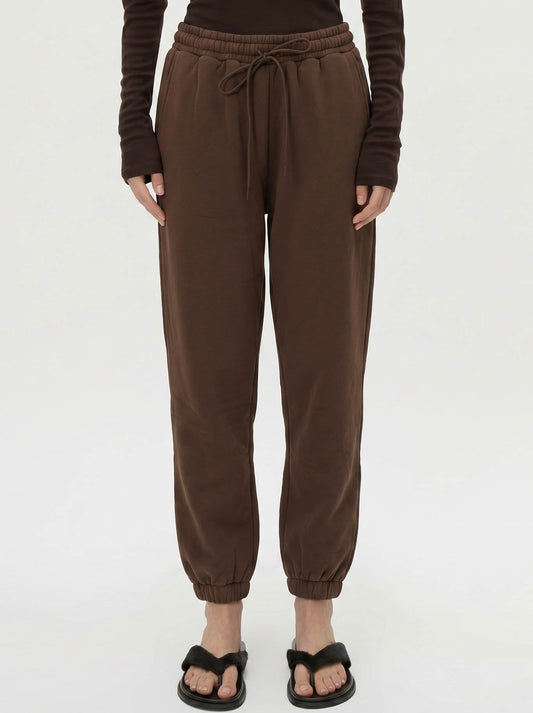 Image of a model wearing Pants. Product name - CAMILLA AND MARC MAREN TRACKPANT in Chocolate colour by brand - Camilla And Marc
