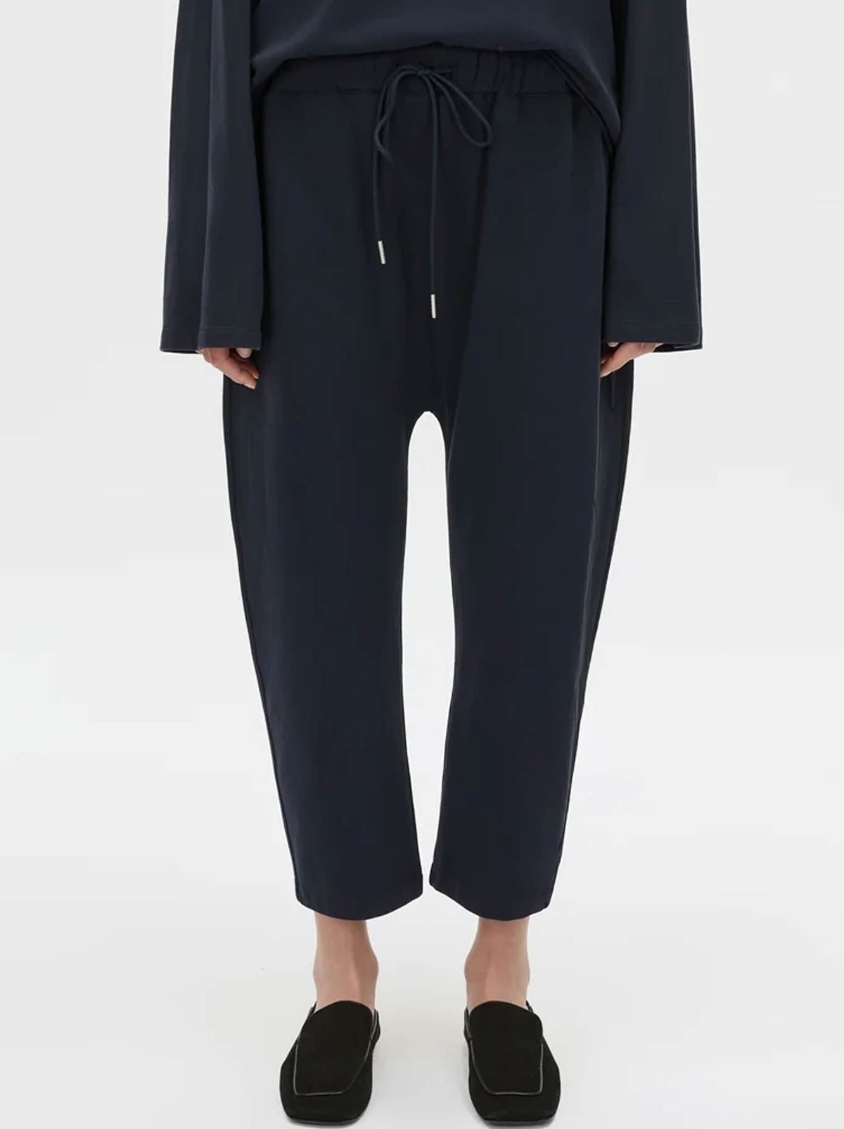 Image of a model wearing Pants. Product name - CAMILLA AND MARC MORENO PIQUE TRACK PANT in Navy colour by brand - Camilla And Marc