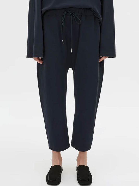 Image of a model wearing Pants. Product name - CAMILLA AND MARC MORENO PIQUE TRACK PANT in Navy colour by brand - Camilla And Marc