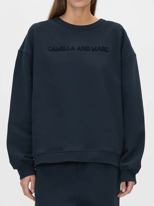 Image of a model wearing Tops. Product name - CAMILLA AND MARC TIA FLOCKING LOGO CREW in Ink colour by brand - Camilla And Marc