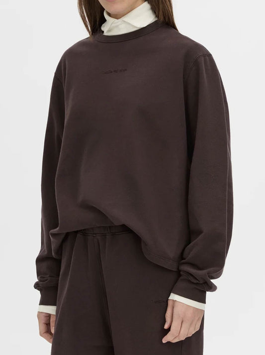 Image of a model wearing Tops. Product name - CAMILLA AND MARC THOME EMB RELAXED TRACK TOP in Hickory colour by brand - Camilla And Marc