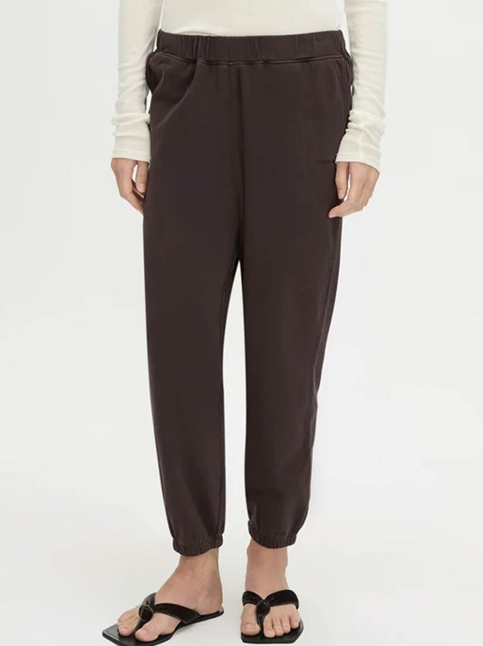 Image of a model wearing Pants. Product name - CAMILLA AND MARC THOME EMB TRACK PANT in Hickory colour by brand - Camilla And Marc