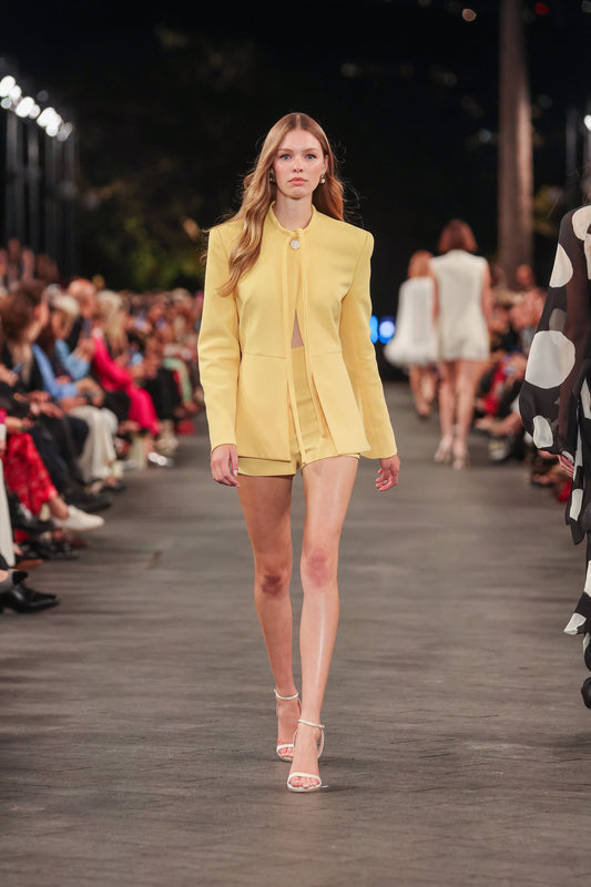 Image of a model wearing Pants. Product name - Pollen Crepe Micro Shorts in Print colour by brand - Carla Zampatti