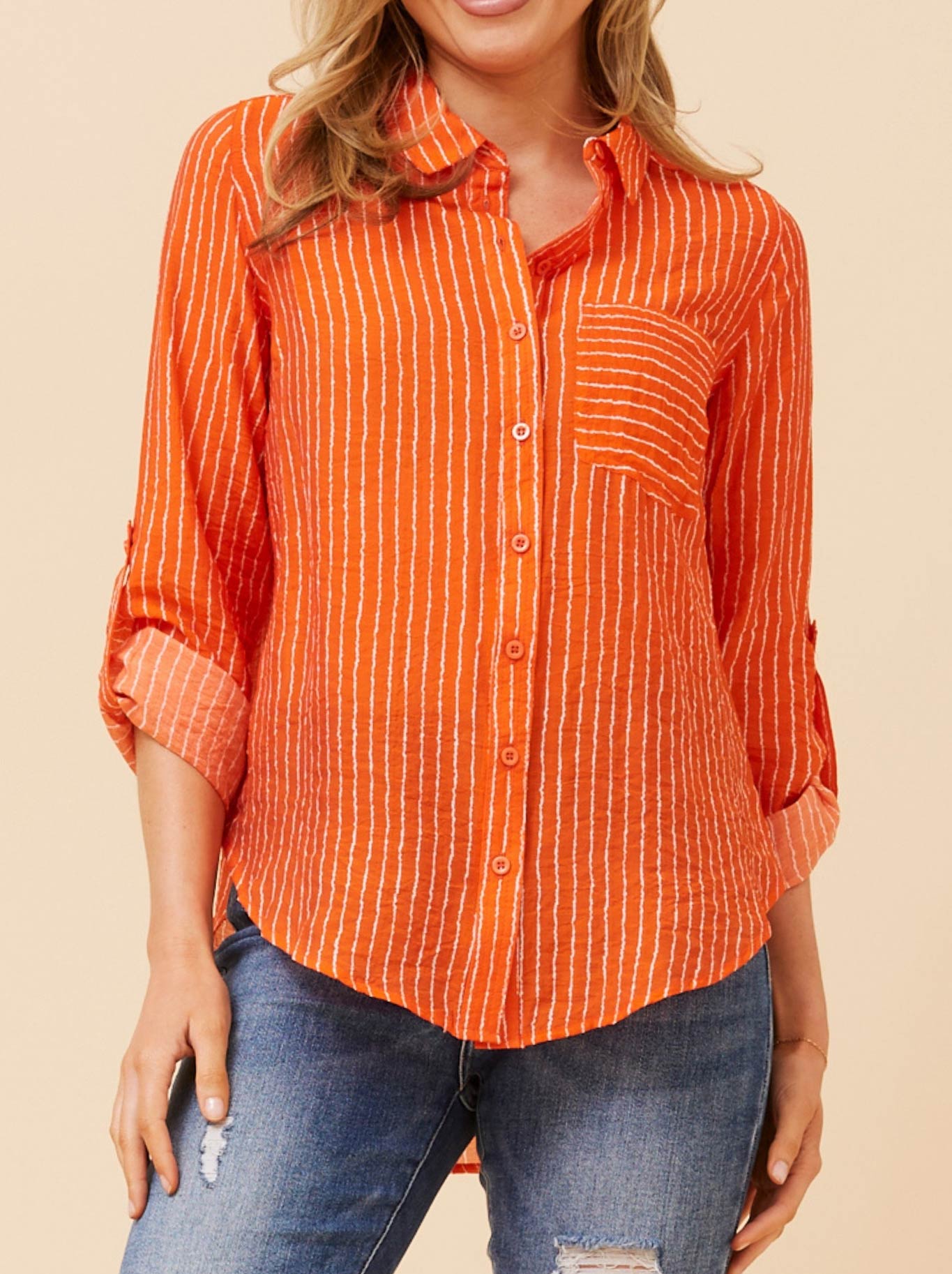 Image of a model wearing Tops. Productname: Caroline K Morgan Striped Long Sleeve Shirt in Orange Stripe colour by brand - Caroline K Morgan Pty Ltd