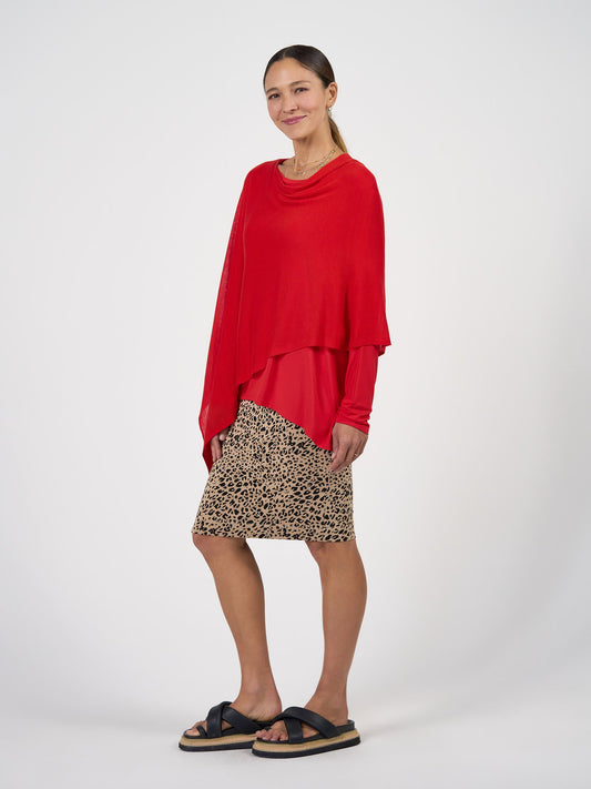 Image of a model wearing Tops. Product name - Carrie Cashmere & Bamboo Knit Poncho Fiery Red in Fiery Red colour by brand - Lou Lou