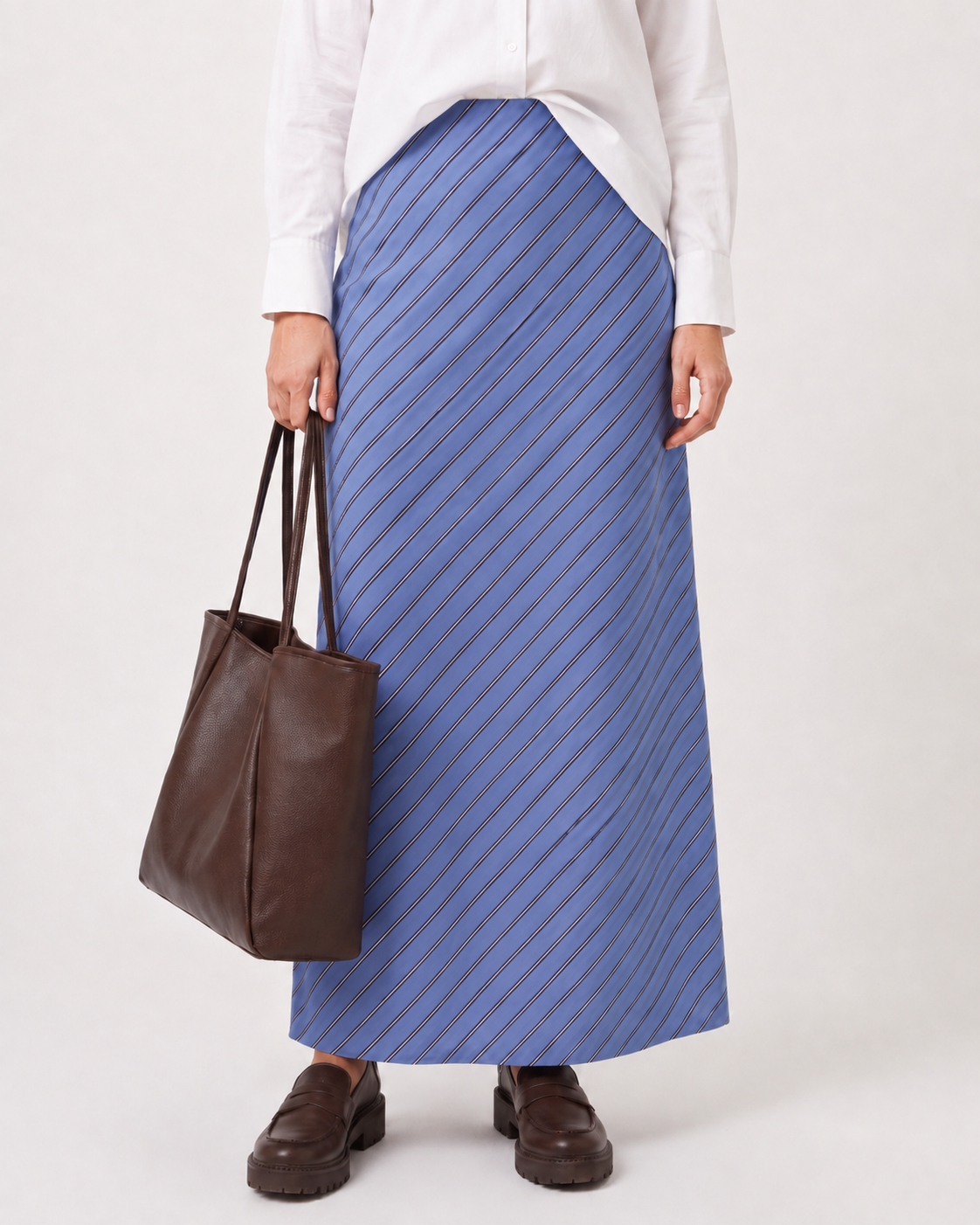 Image of a model wearing Skirts. Product name - Alba Skirt Cornflower Blue in Cornflower Blue colour by brand - Foxwood