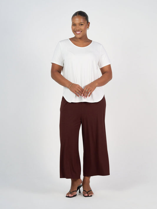 Image of a model wearing Pants. Product name - Ciara 7/8 Length Bamboo Culotte Pant Burgundy in Burgundy colour by brand - Lou Lou